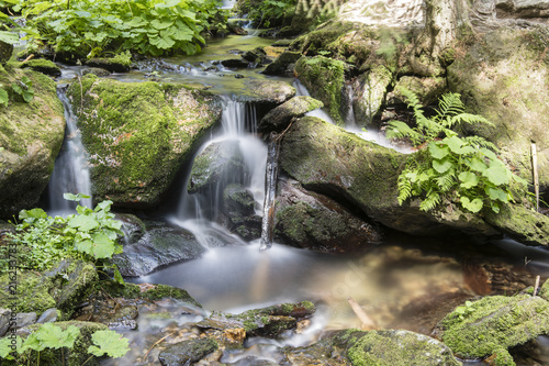 Fototapeta Naklejka Na Ścianę i Meble -  Small waterfalls on a river flowing in nature.