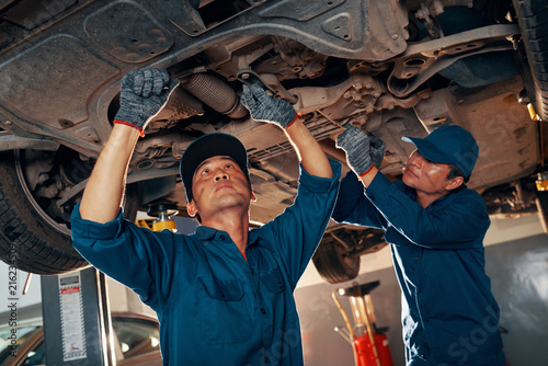 Mechanics fixing car