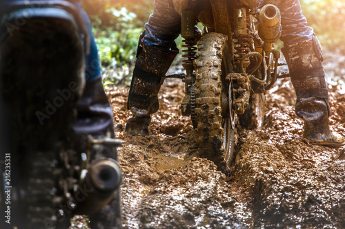 Fototapeta Naklejka Na Ścianę i Meble -  Motocross rider in mud road. wheel close up.
