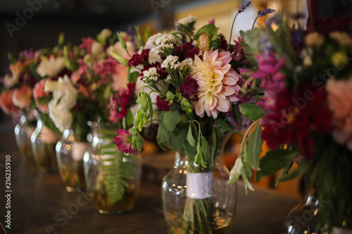 Bride and Bridesmaid s Floral Bouquets in Vases on a Bar - Pink  White  Green  and Purple Wedding Flower Arrangements