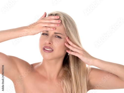 A young woman with a headache holding head, isolated on white background.