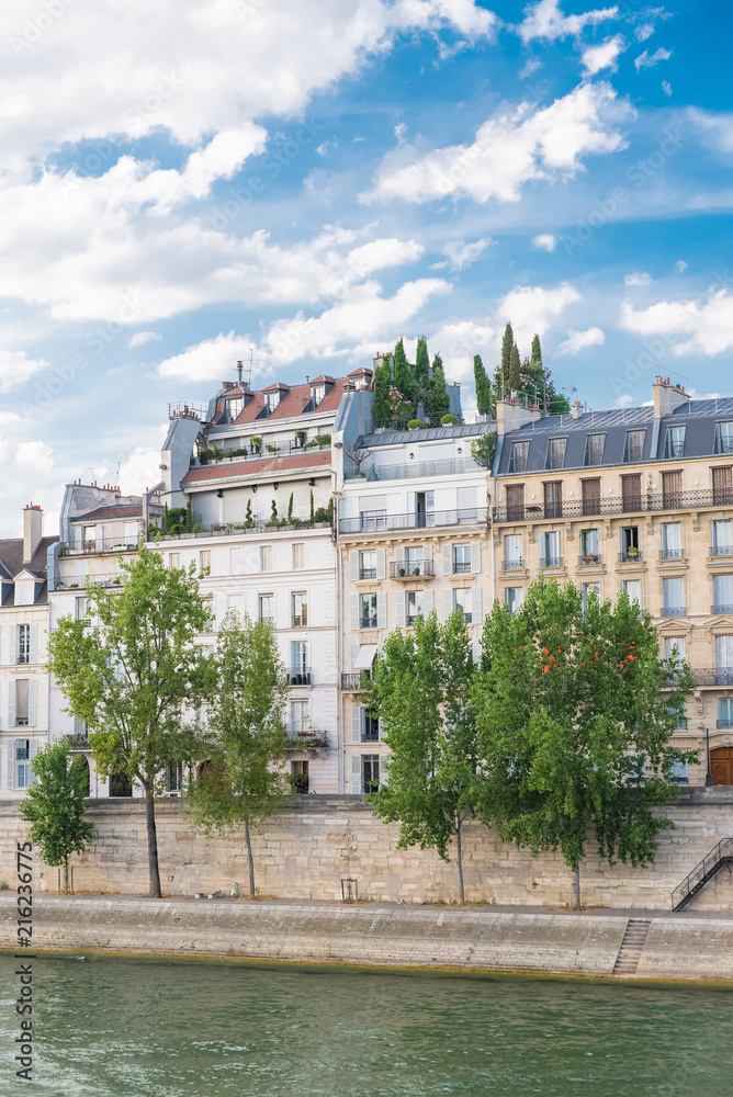 Paris, view of ile saint-louis and quai de Bethune, beautiful buildings with a terrace on the roof
