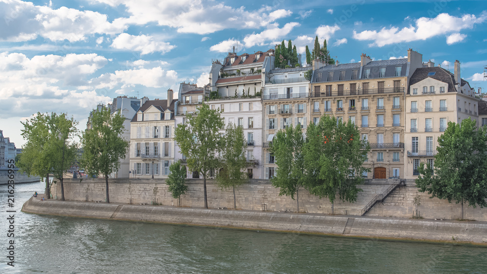 Paris, view of ile saint-louis and quai de Bethune, beautiful buildings and banks of the Seine in summer 
