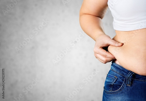 Fotografía Woman's hand holding excessive belly fat
