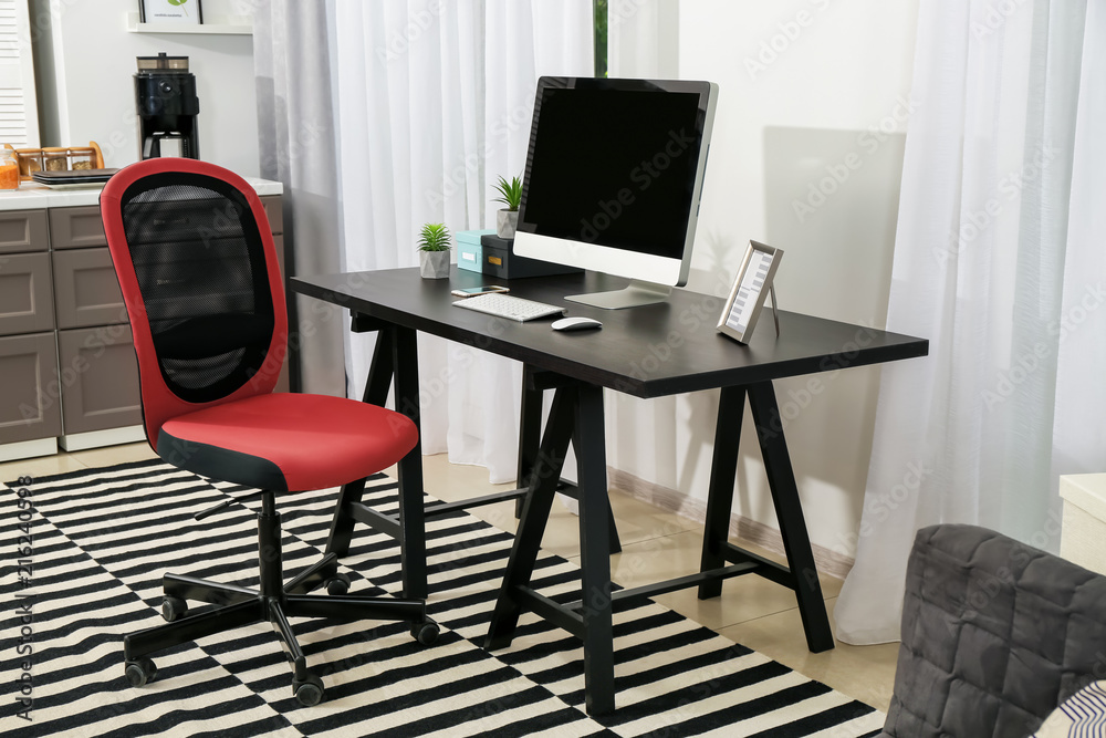 Comfortable workplace with monitor in interior of beautiful modern room Comfortable workplace with monitor in interior of beautiful modern room