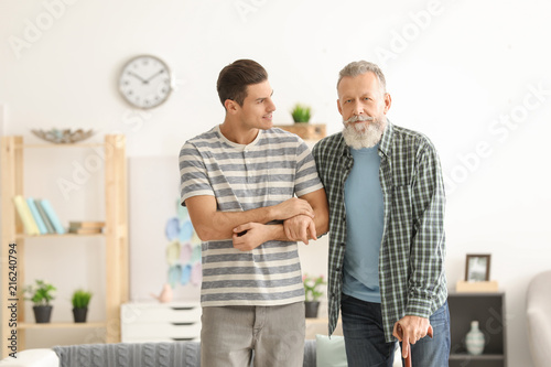 Young caregiver with senior...
