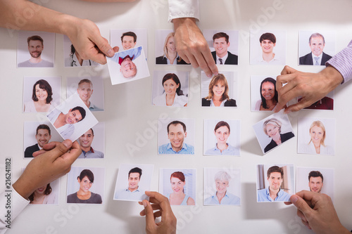 Group Of Businesspeople Selecting Candidate Photo