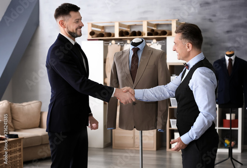 Tailor shaking hands with c...