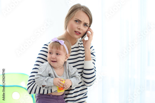 Young nanny holding girl wh...