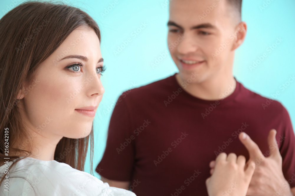 Young woman dancing with her boyfriend on color background Young woman dancing with her boyfriend on color background