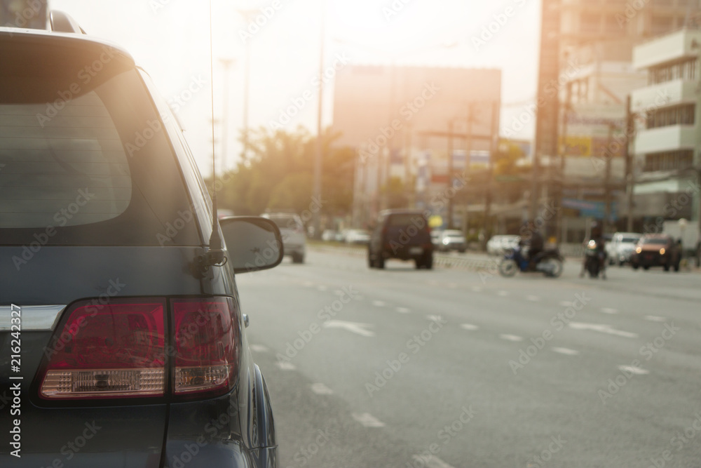 Black car stop or parked on the road with easy to travel on evening in the city.