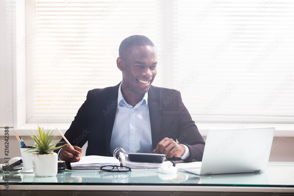 Smiling African Businessman Working At Workplace Smiling African Businessman Working At Workplace