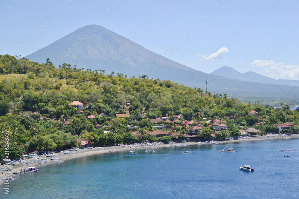 Amed beach and blue lagoon with volcano Agung on background. Amed village, East of Bali, Indonesia.