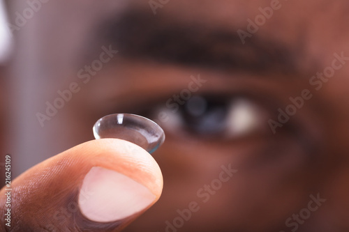 Man Holding Contact Lens In His Finger
