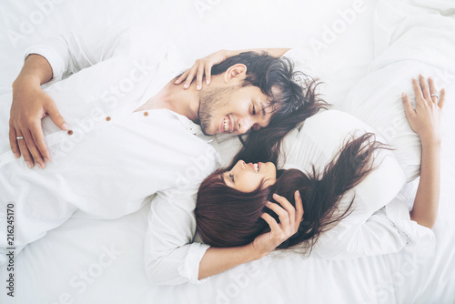 Happy young couple relaxing in the home bedroom. photo