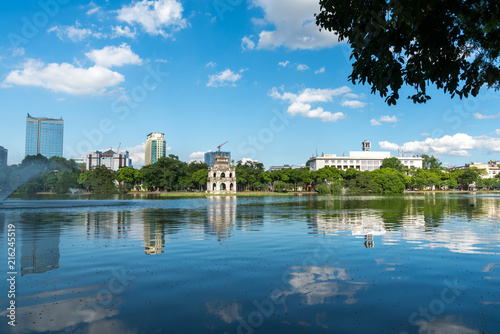 Hoan Kiem lake or Sword lake, Ho Guom in Hanoi, Vietnam with Turtle Tower, on clear day with blue sky and white clouds © Hanoi Photography