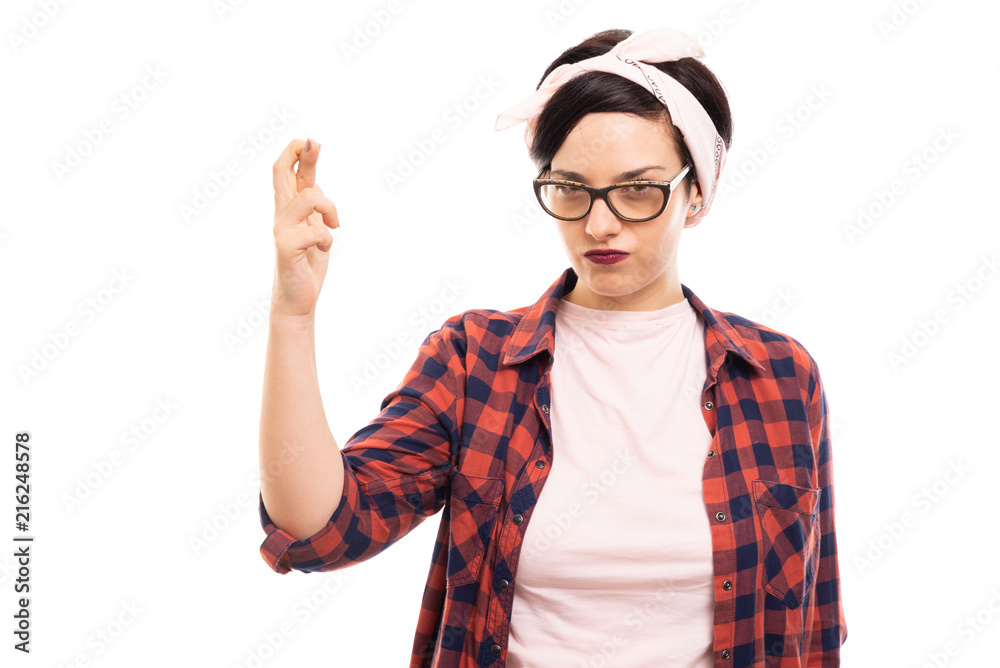 Young pretty pin-up girl wearing glasses showing cross finger gesture. Young pretty pin-up girl wearing glasses showing cross finger gesture.