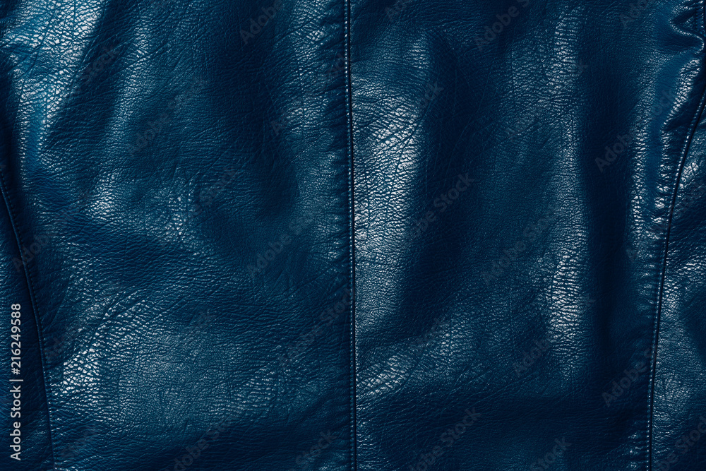 Fototapeta premium elevated view of dark blue leather shiny textile as background