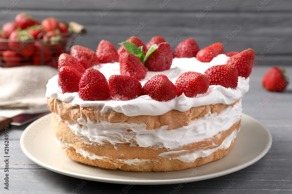 Plate with delicious strawberry cake on table Plate with delicious strawberry cake on table