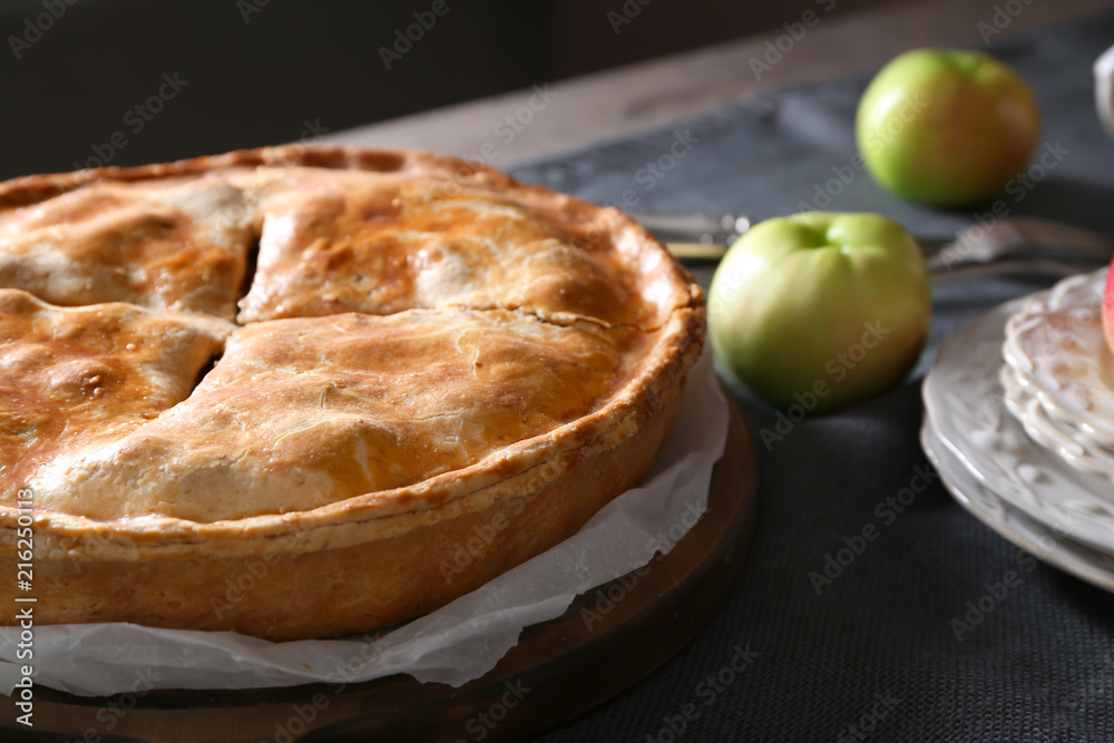 Board with delicious apple pie on table, closeup Board with delicious apple pie on table, closeup