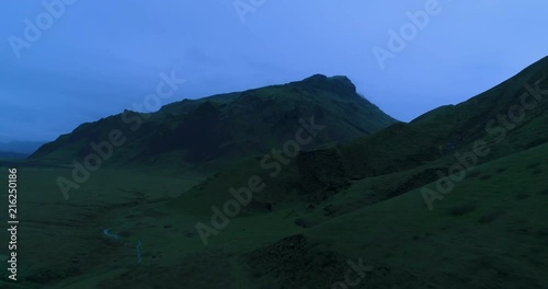 Aerial of green Icelandic mountains during twilight