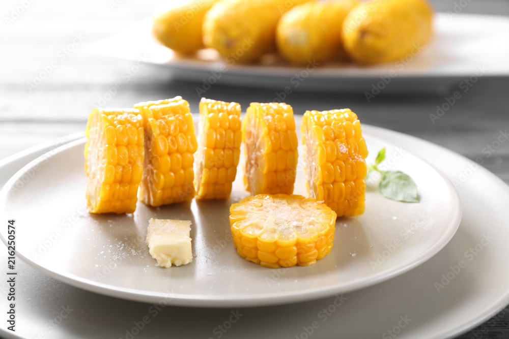 Plate with cut boiled corncobs on table, closeup Plate with cut boiled corncobs on table, closeup