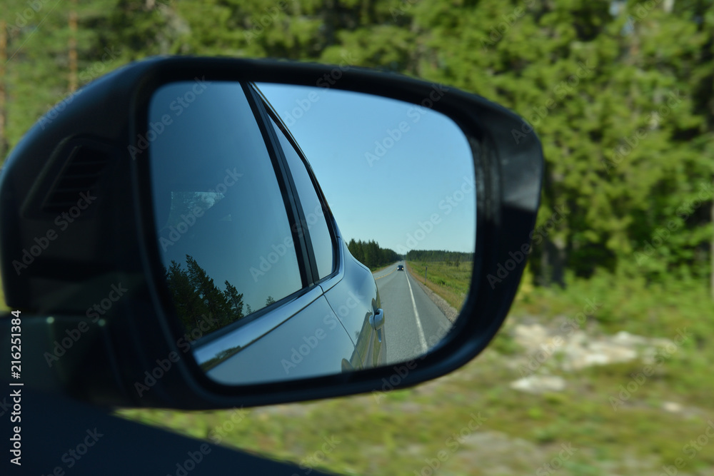 Road in car mirror. Speed