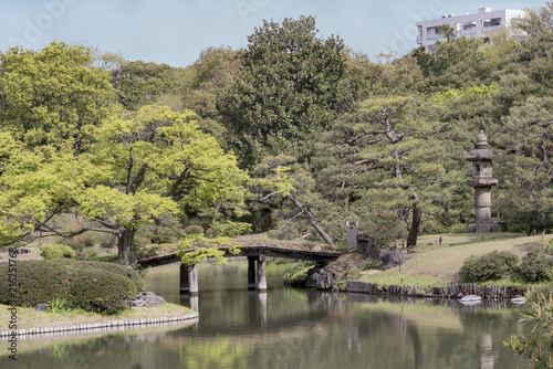 The wooden japanese bridge Dentsuru Bride on the pond of Rikugien Park in Bunkyo district, north of Tokyo. photo