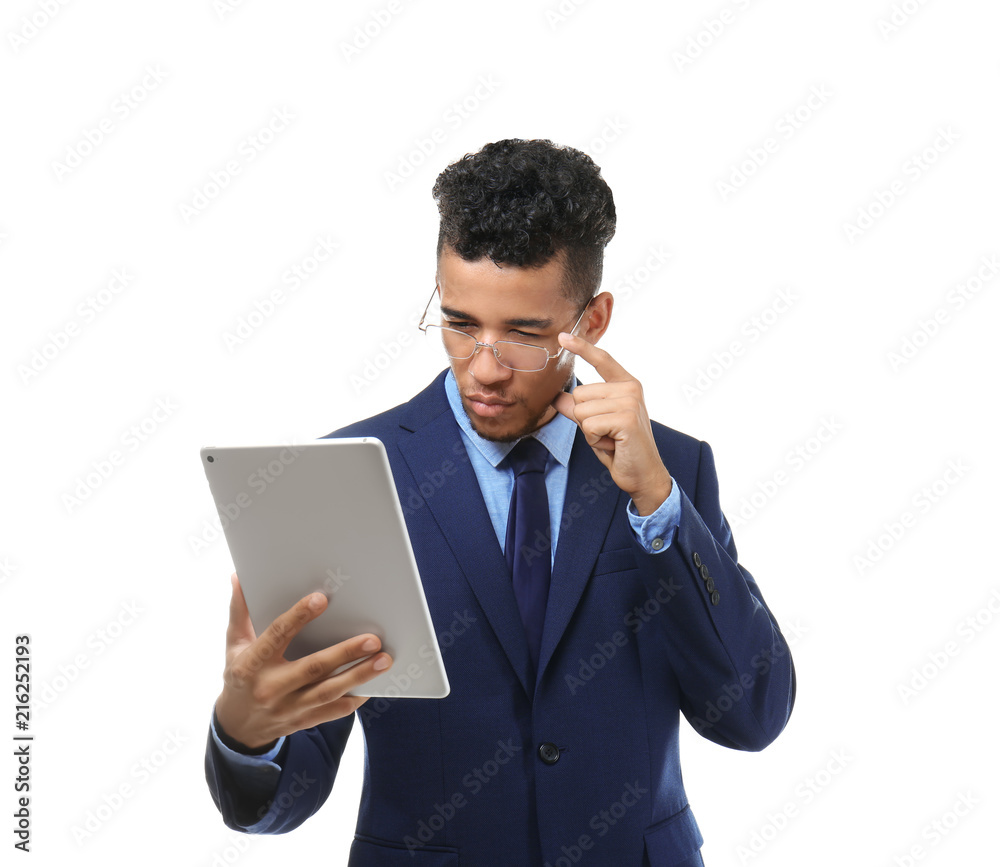 Handsome African-American businessman with tablet computer on white background Handsome African-American businessman with tablet computer on white background