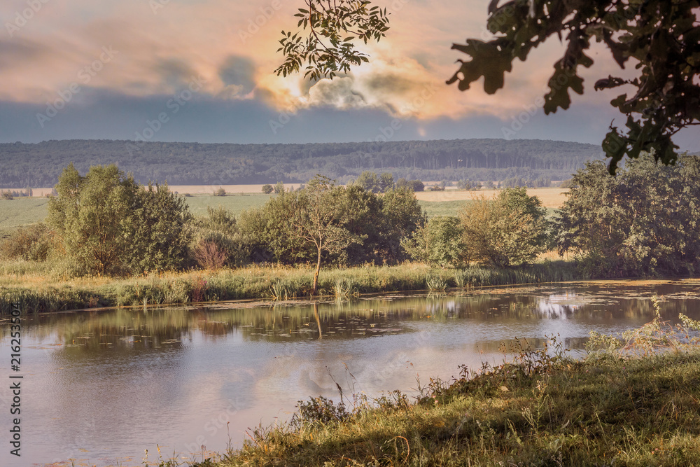 River and trees at sunset. Summer landscape. Trees are displayed in the river_ River and trees at sunset. Summer landscape. Trees are displayed in the river_
