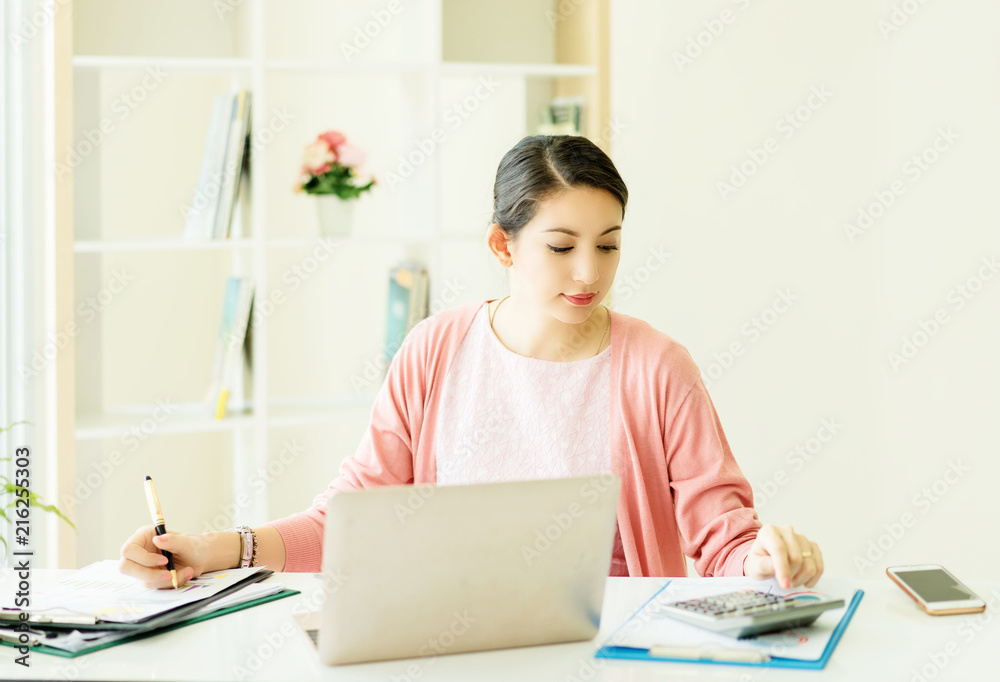 happy young woman working on laptop in workplace.entrepreneur working at start up.Business woman in office start-up working on laptop. happy young woman working on laptop in workplace.entrepreneur working at start up.Business woman in office start-up working on laptop.