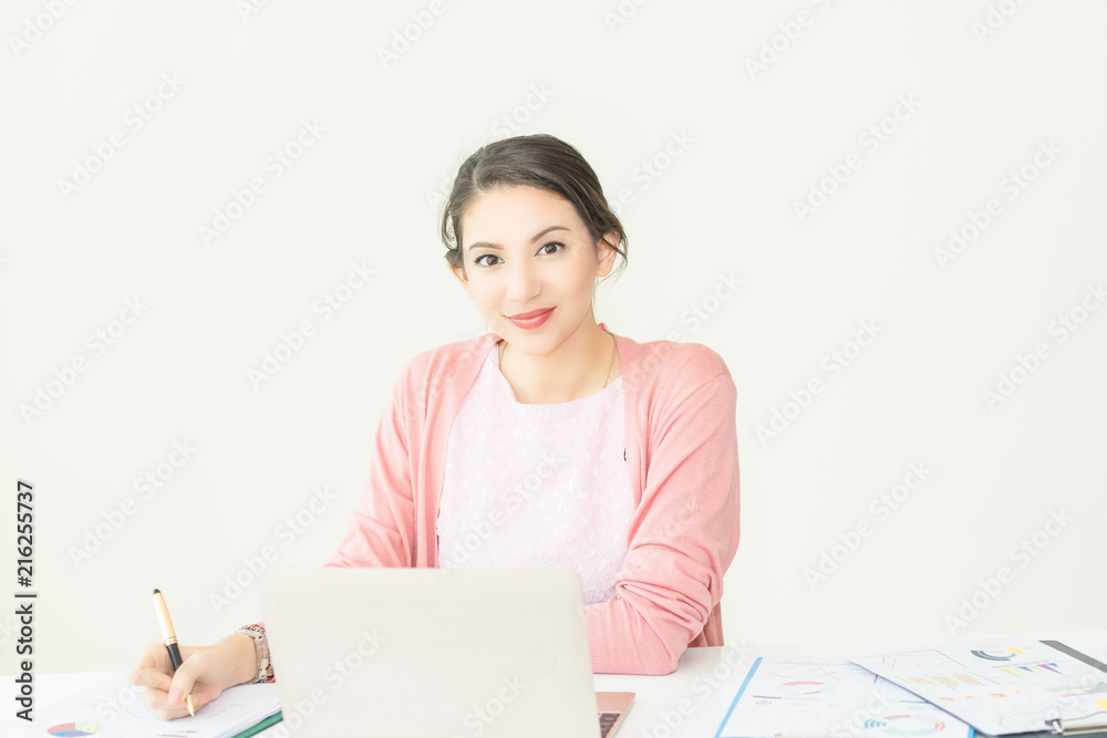 happy young woman working on laptop in workplace.entrepreneur working at start up.Business woman in office start-up working on laptop. happy young woman working on laptop in workplace.entrepreneur working at start up.Business woman in office start-up working on laptop.