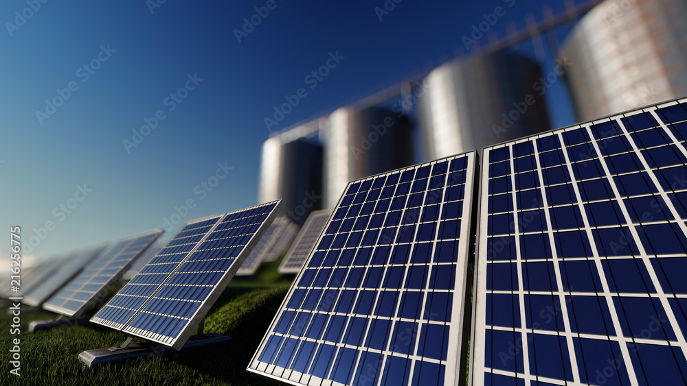 Obraz premium Solar Farm with Silos Behind on a Bright Day