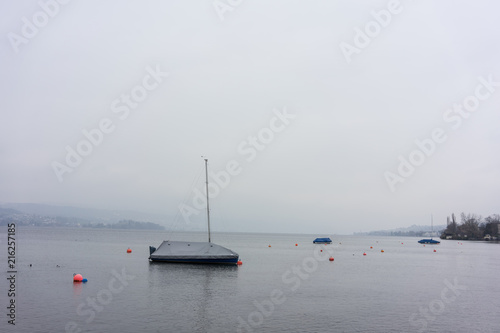 boats on foggy lake in winter cold lonely mood concept