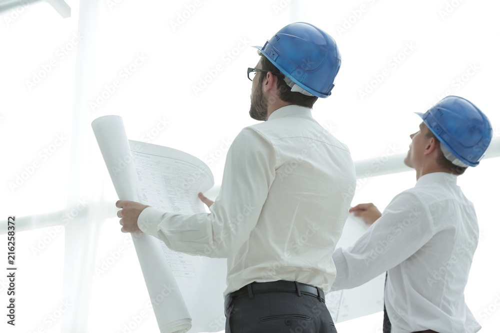 rear view.architect and Builder looking at blank screen rear view.architect and Builder looking at blank screen