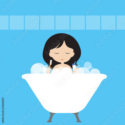 Young woman or girl is washing in a white bath with foam and cleanses her teeth with a toothbrush and a paste in a blue bathroom