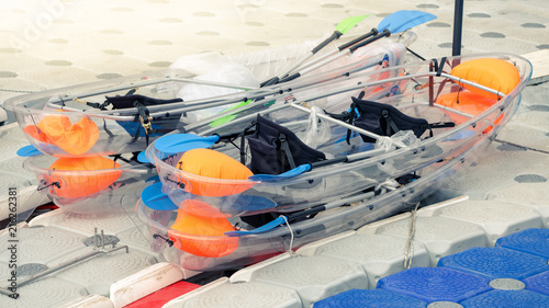 Obraz na płótnie Transparent plastic canoes stay on port. w salonie