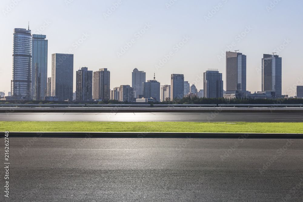 Fototapeta premium Panoramic skyline and modern business office buildings with empty road,empty concrete square floor