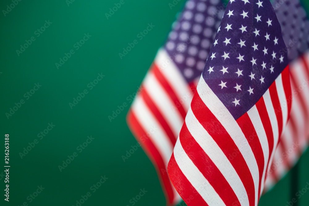 Obraz premium Flags United States of America with green background empty space for your text on left.