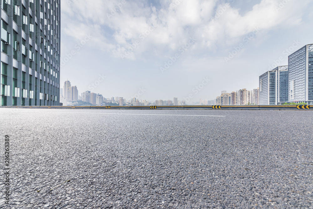 Panoramic skyline and modern business office buildings with empty road,empty concrete square floor Panoramic skyline and modern business office buildings with empty road,empty concrete square floor