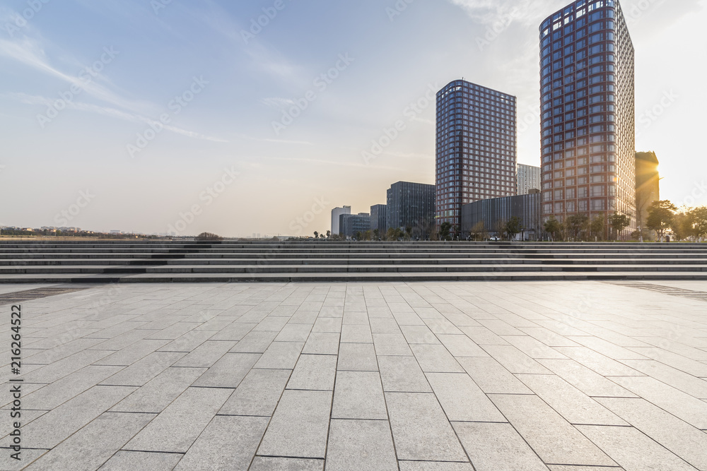 Panoramic skyline and modern business office buildings with empty road,empty concrete square floor Panoramic skyline and modern business office buildings with empty road,empty concrete square floor