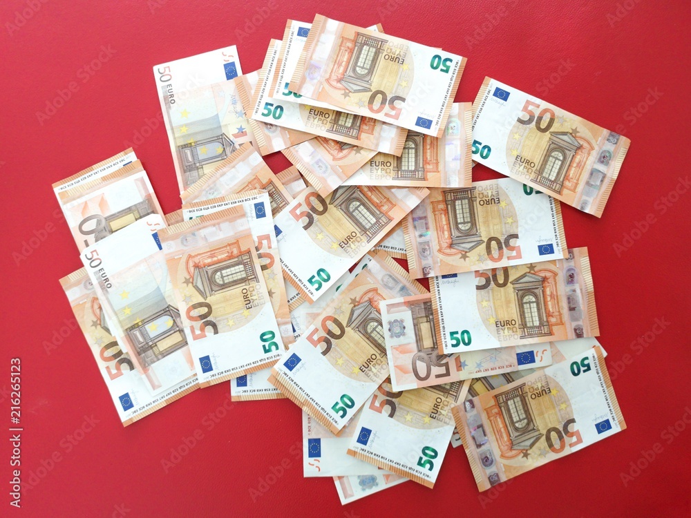 European money fifty euro bills on red carpet, euro money overflowing background, euro bank notes