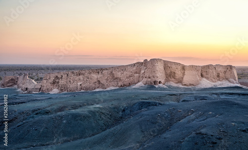 Wall of Djanpik Qala: 9-10th century Khorezm fotress on sunset, Karakalpakstan region, Uzbekistan photo