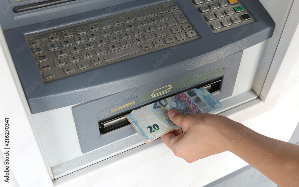 withdrawing cash from an ATM withdrawing cash from an ATM