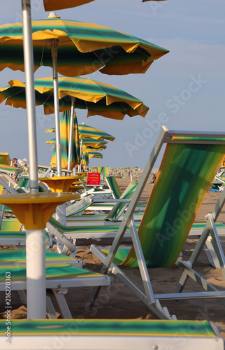 summer beach with umbrellas and deck chairs