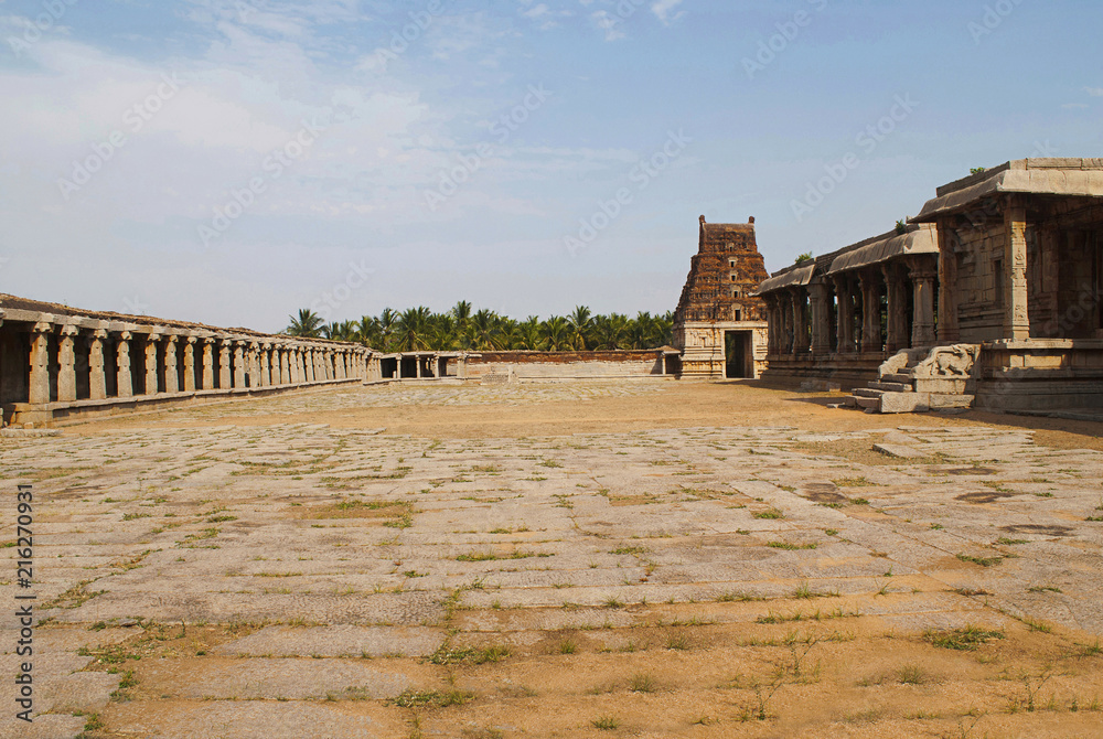 The prakara on the left, east gopura and the side, north, entrance to the ardha-mandapa, Pattabhirama Temple, Hampi, Karnataka. View from west.