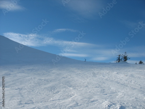 Winter slopes of a mountain resort in ukraine with white slopes and blue sky
