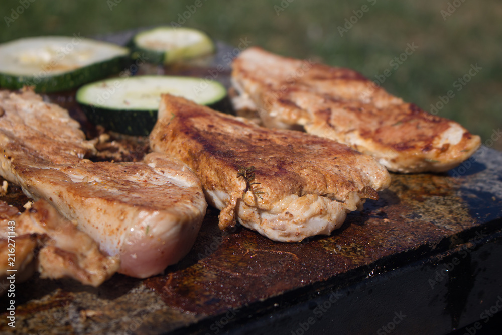 Grilling chicken breast and vegetables on the stone, hot meat dishes Grilling chicken breast and vegetables on the stone, hot meat dishes