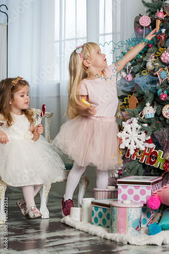 Two cute little girls in a festive New Year's atmosphere