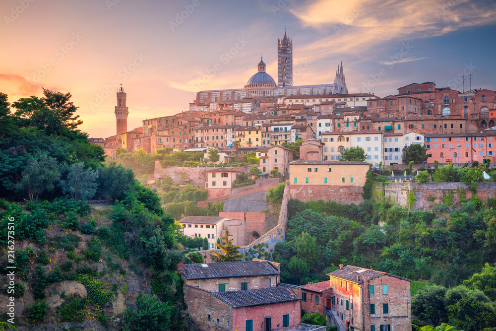 Siena. Cityscape aerial image of medieval city of Siena, Italy during sunrise.